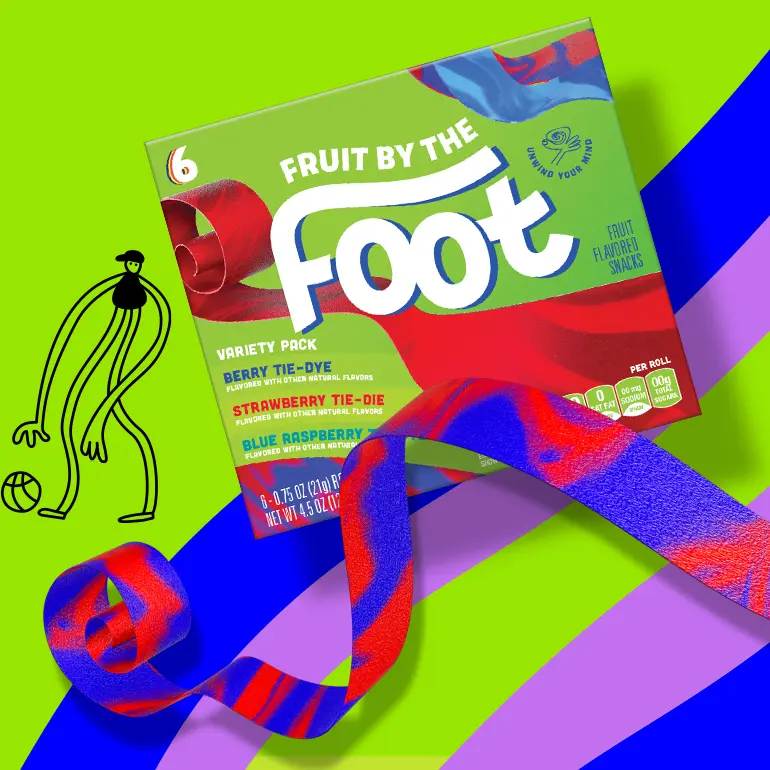 Fruit by the Foot Variety pack including Berry Tie-Dye, Strawberry Tie-Die, and Blue Raspberry Tie-Dye flavors, front of pack with multi-colored strips and small illustration next to it